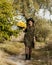 Beautiful girl with a bouquet of yellow roses. Woman with model appearance in a hat. Pretty woman. Teenager girl in a black hat