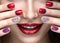 Beautiful girl with a bright evening make-up and red manicure with rhinestones. Nail design. Beauty face.