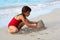 Beautiful girl building a sand castle in the beach