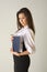 Beautiful girl in business outfit holding notebook