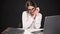 Beautiful girl in business style posing at desk with laptop