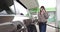 Beautiful Girl Business Woman Holds A Gun To Refuel The Car And Smiles At The Camera. Gas Station Gas Pump Close Up