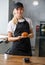 Beautiful girl in a cafe and bakery holding a croissant