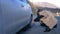 Beautiful girl changing the wheel of a car parked on the roadside