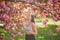 Beautiful girl in cherry blossom garden on a spring day