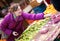 Beautiful girl choosing fruits at fruit market