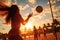 Beautiful girl close-up view in a sand beach volleyball game at sunset. Summer tropical vacation concept.