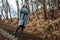 Beautiful girl in a coat walks down stairs in autumn Park. copy space