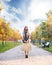 Beautiful girl with coloured hair holding a suitcase