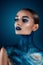 Beautiful girl with creative make-up . Bright colors blue lips. Conceptual art the cosmos, the universe