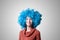 Beautiful girl with curly blue wig and turtleneck