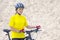 Beautiful girl cyclist with bike against the background of the Sands. sports and recreation. Nature and man