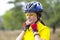 Beautiful girl cyclist in yellow wearing a helmet. Sports and recreation