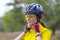 Beautiful girl cyclist in yellow wearing a helmet. Sports and recreation