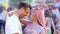 Beautiful girl dancing with handsome man, smiling couple flirting at festival