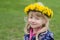 Beautiful girl with dandelion chain