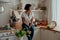 Beautiful girl with dark hair in the kitchen with wine and food