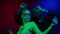 Beautiful girl in the disco club. Pretty girl moving in neon light on black background. Beautiful girl dancing in