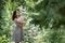 Beautiful girl in dress with long hair standing in woods