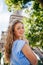 A beautiful girl in a dress poses near the Eiffel Tower