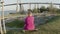 Beautiful girl in dress sitting on longboard in skate park