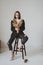 beautiful girl with dried flowers sits on a chair in a beautiful scandi room and poses for a photo