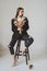 beautiful girl with dried flowers sits on a chair in a beautiful scandi room and poses for a photo