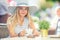 Beautiful girl drinking coffee in a cafe terrace. Summer portrait young woman