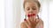 Beautiful girl eating raspberries on her fingers