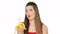 Beautiful girl eats banana on white background