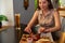 Beautiful girl eats chicken leg with beer in restaurant