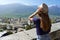 Beautiful girl enjoying panoramic view of Sondrio old town, Valtellina, Italy