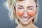 Beautiful girl fashion portrait. Wearing wet glasses with water drops visible. Winking and biting lips
