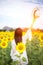 Beautiful girl in field of sunflowers, so happy and relax