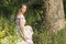 Beautiful girl in the field. Women sits on a rock, enjoying the outdoors and the sun.