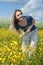 Beautiful girl in field with yellow flower