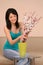 Beautiful girl with flowers. Beautiful young woman arranging flo