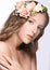 Beautiful girl with flowers in her hair and pink makeup. Spring image. Beauty face.