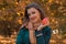 Beautiful girl in frenzy Brown scarf keeps an Apple and a smiling close-up