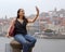 Beautiful girl in front of the skyline of Porto in Portugal - CITY OF PORTO, PORTUGAL - OCTOBER 16, 2019