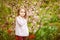 Beautiful girl in garden with almond bush  tulips