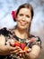 Beautiful girl is giving you strawberries during a sunny day