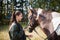 A beautiful girl is happy with her horse and shows her love and tenderness