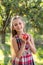 Beautiful girl harvests apples. Apple orchard.