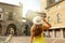 Beautiful girl with hat visiting Piazza Vecchia square in Bergamo Citta Alta medieval old city of Lombardy region in Italy