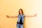 Beautiful girl with her hair standing on yellow background. She with all her appearance portrays the emotion of passion a