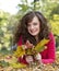 Beautiful girl holding autumn leafs