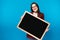 Beautiful girl holding a blackboard. study emotions