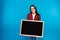 Beautiful girl holding a blackboard. study emotions