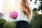 Beautiful girl holding bouquet of pink roses flowers on dating in the city.